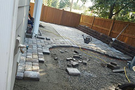 Maintenance — Brick Backyard With Retaining Wall During In Everett, WA