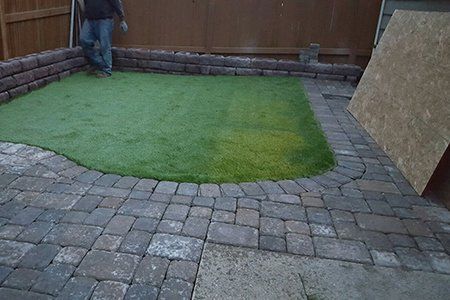 Sod Installation — Brick Backyard With Retaining Wall And New Sod Finished In Everett, WA