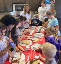 A group of people are sitting around a table eating food.