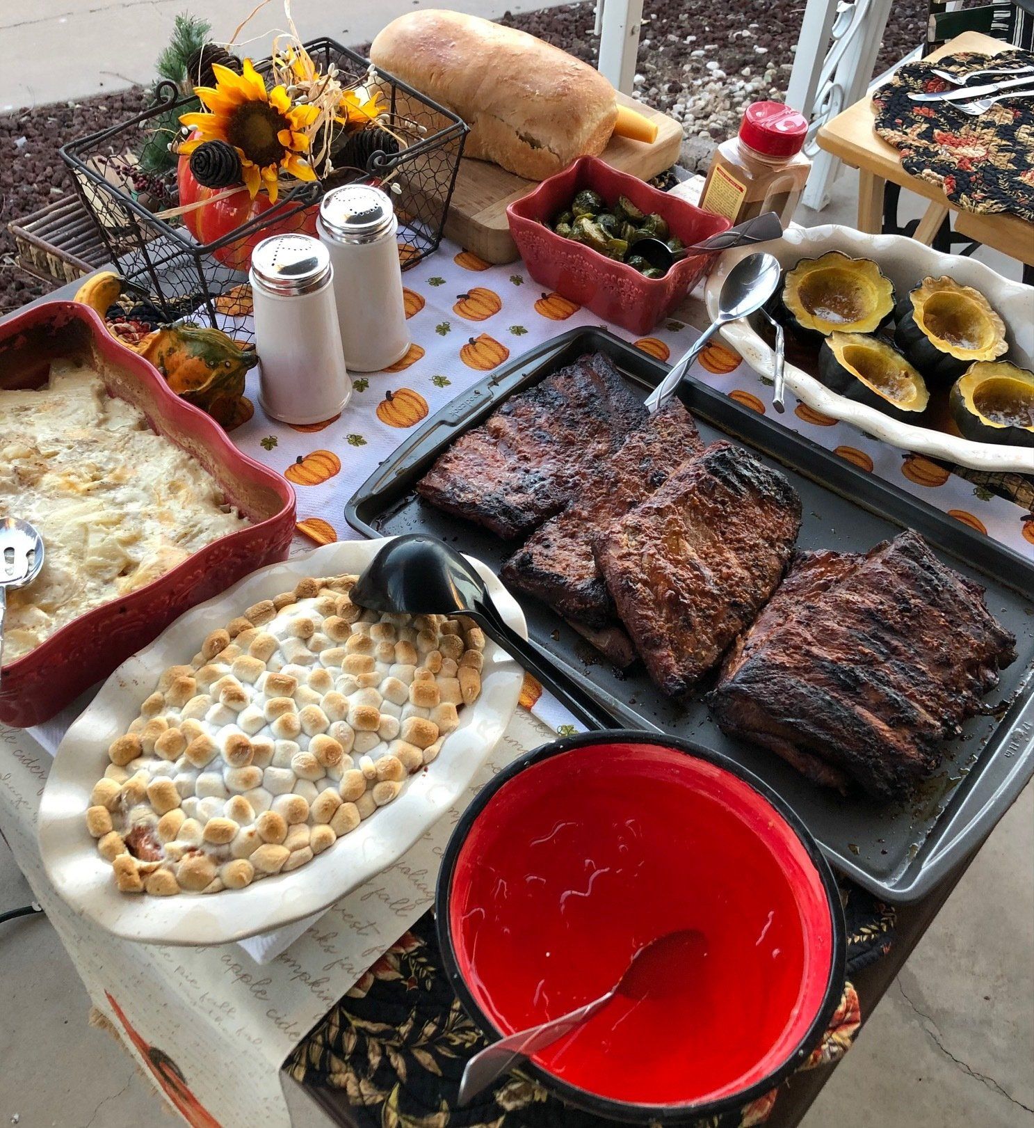 A table topped with plates of food and a bowl of sauce.