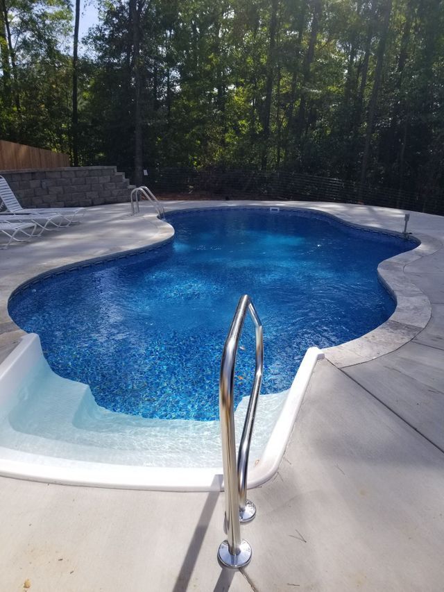 A large swimming pool with a staircase leading to it