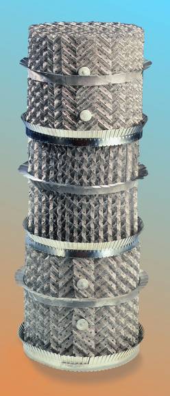 A stack of metal tubes stacked on top of each other on a table.