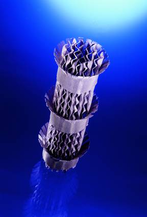 A metal object is stacked on top of each other on a blue surface.