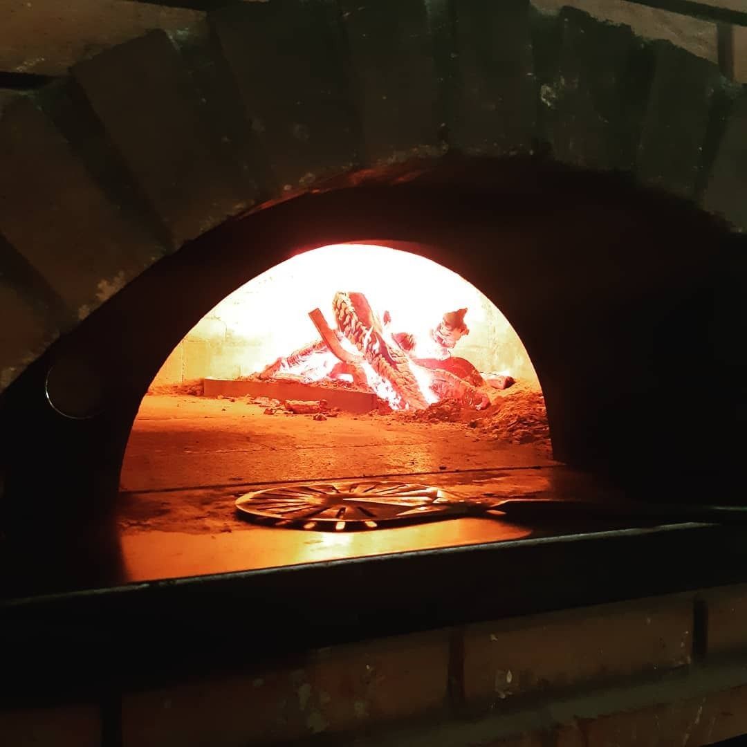Ananas, bottiglie di vino e un cocktail disposti su un bancone. Al centro c'è un piatto di cibo.