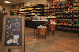 A chalkboard in a store that says welcome to the market