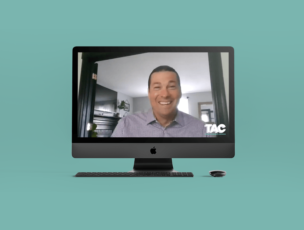 A man is talking on a video call on a computer screen.