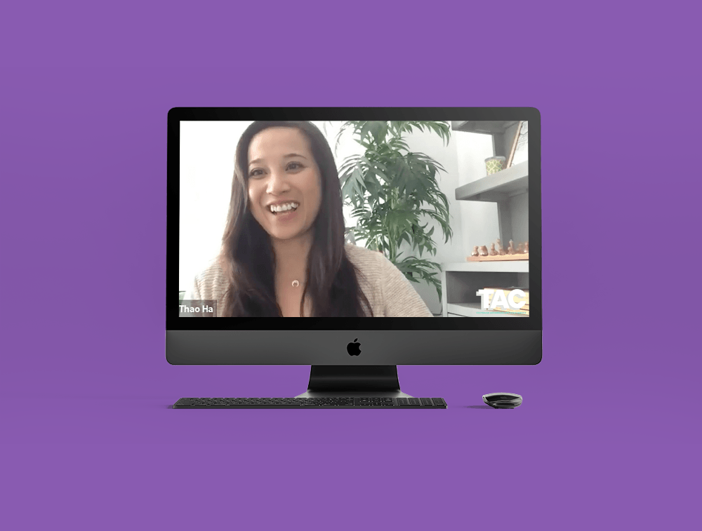 A woman is smiling on the screen of an apple computer