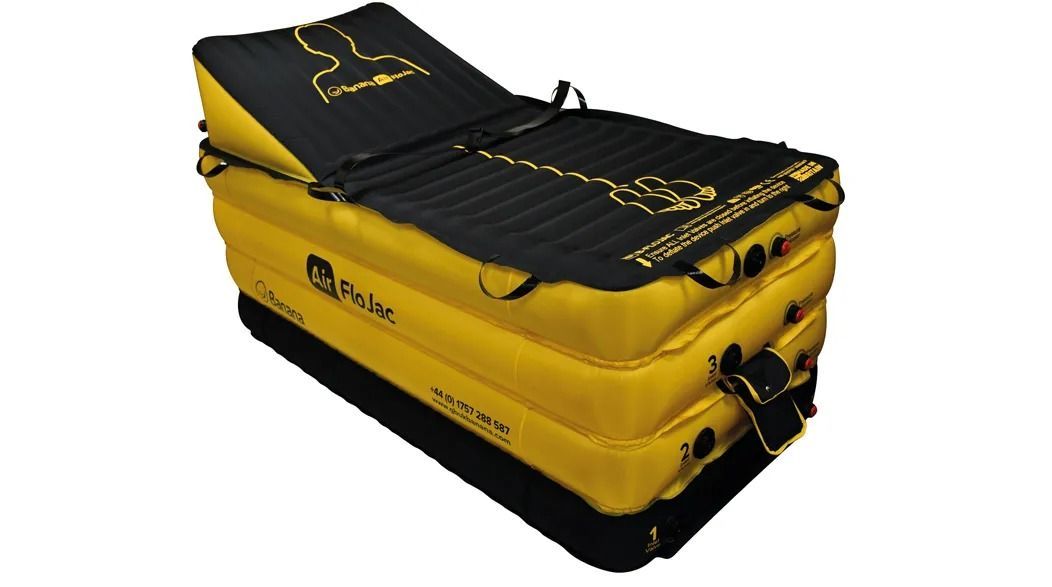 Yellow and black inflatable rescue platform with a headrest and straps.