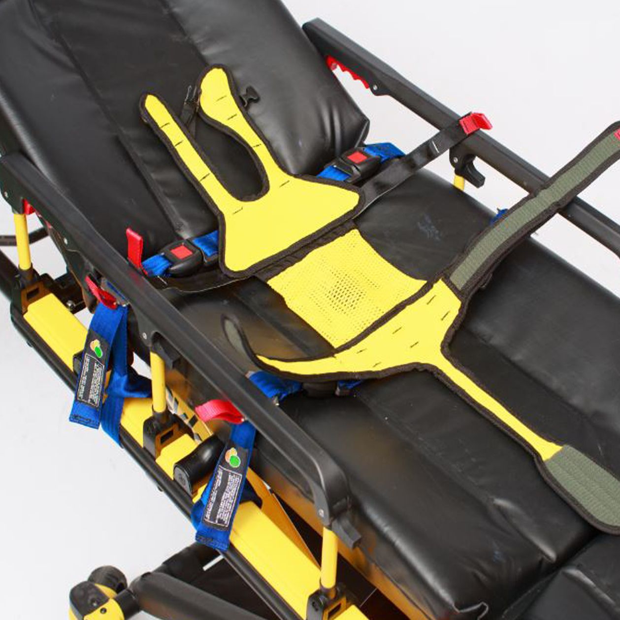 Yellow and black patient restraint system on an ambulance stretcher.