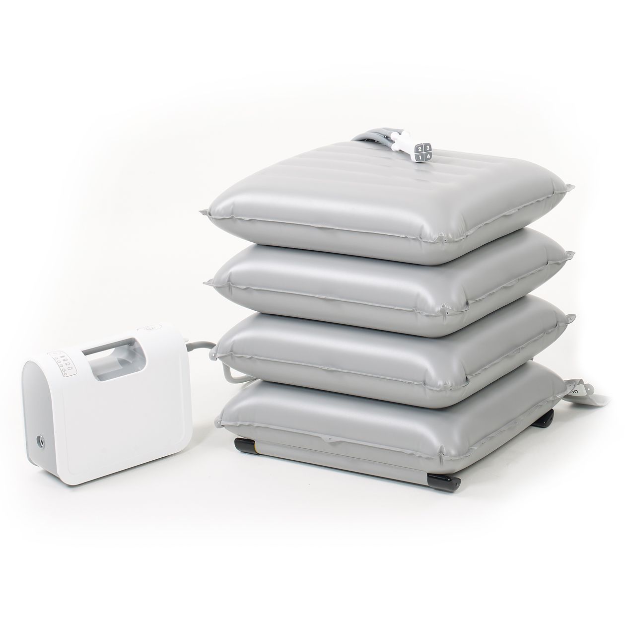 Four gray, inflated cushions stacked with attached air pump on white background.