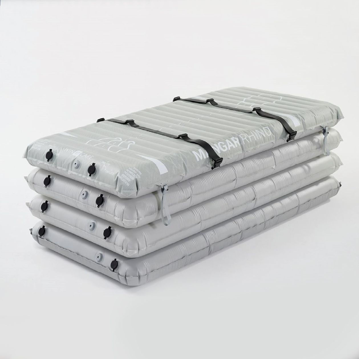 Four gray, inflatable sleeping pads stacked, secured with black straps.