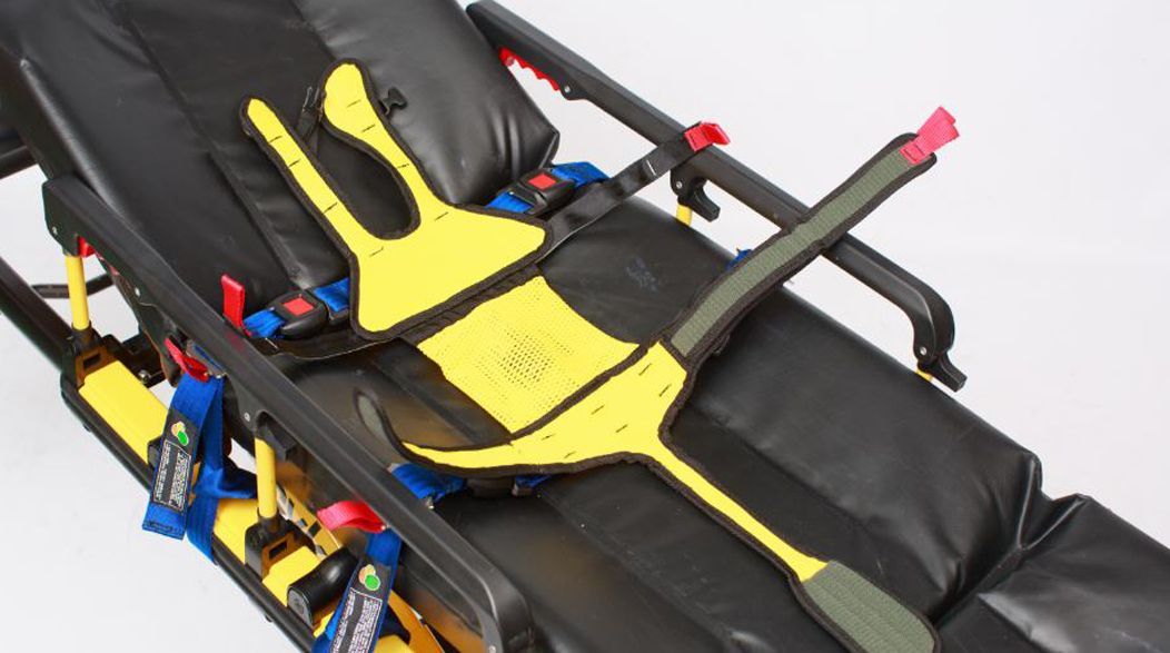 Yellow and black patient restraint straps on an ambulance stretcher.