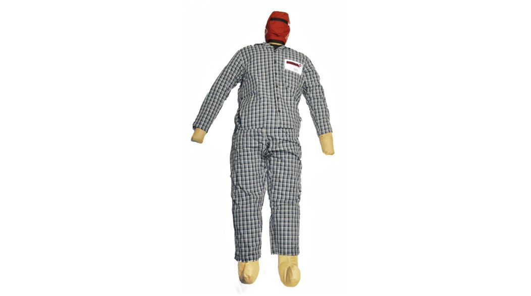 Stuffed figure in checkered jumpsuit and red cap with tan hands and feet.