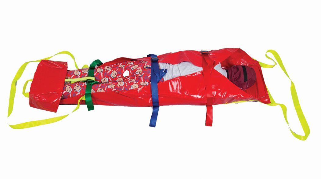 Red emergency stretcher with a person inside, secured by straps and yellow carrying handles.