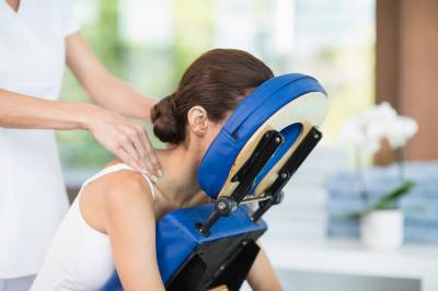 Woman sitting forward in a massage chair
