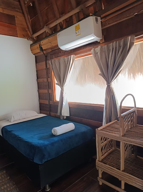 There is a bed in the middle of the room with a window.