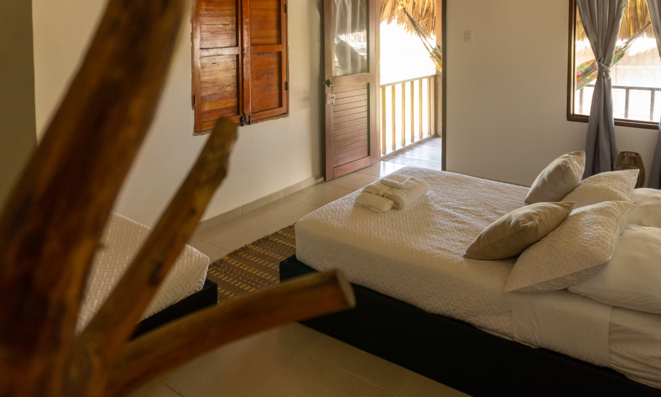 A bedroom with a bed , two beds and a window.