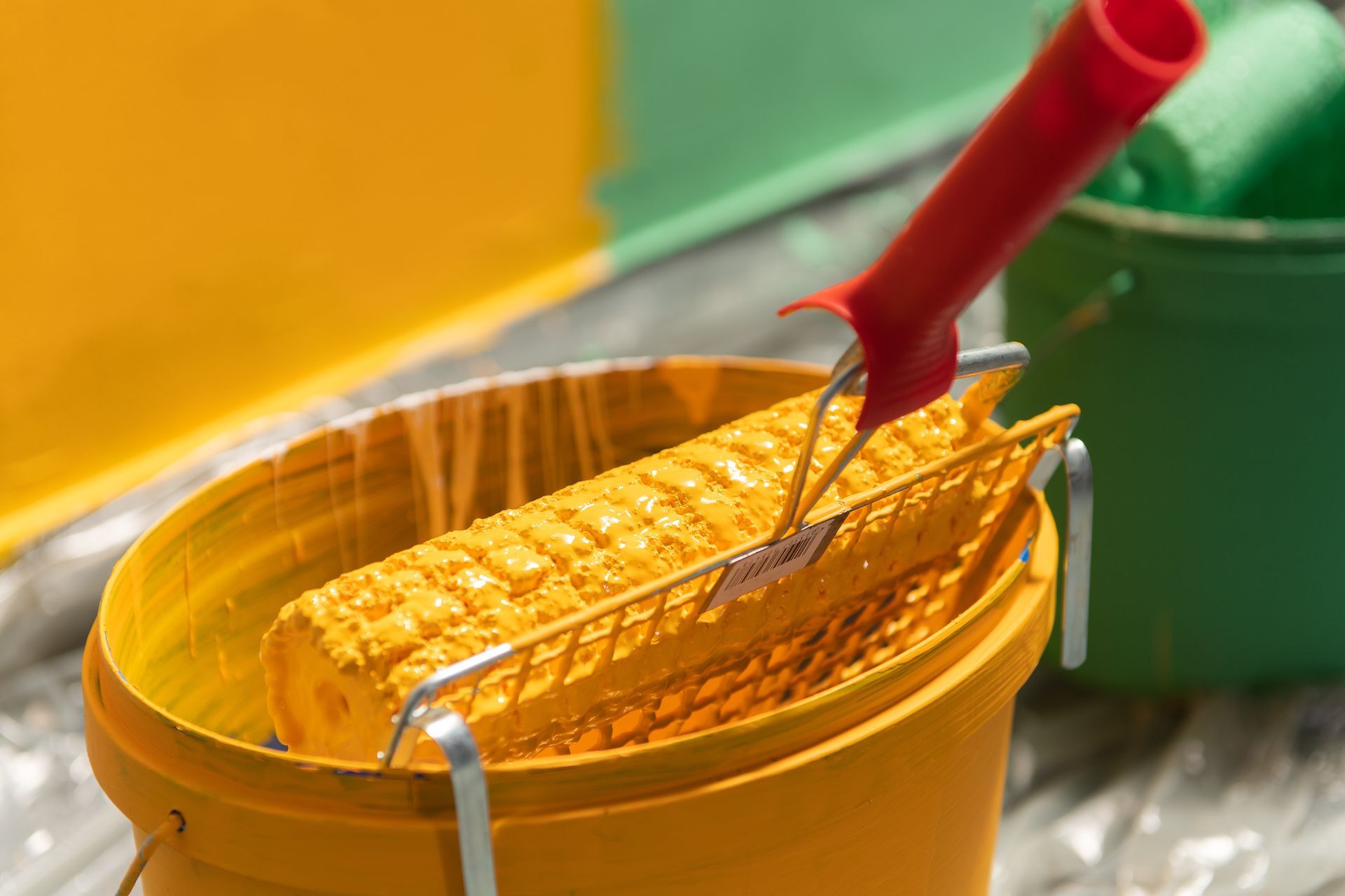 Paint Roller and Bucket of Yellow Paint