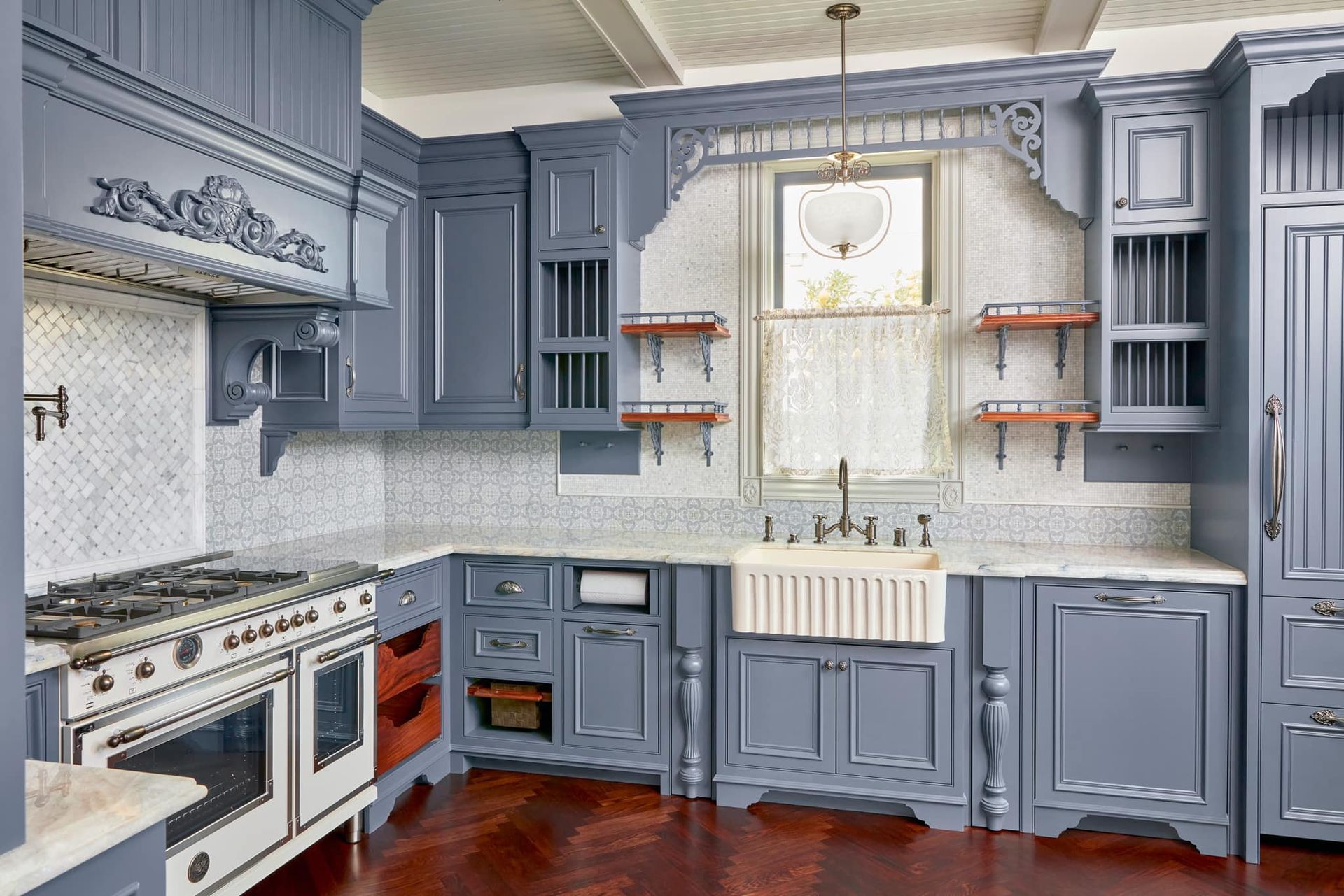 A kitchen with blue cabinets and a white stove top oven