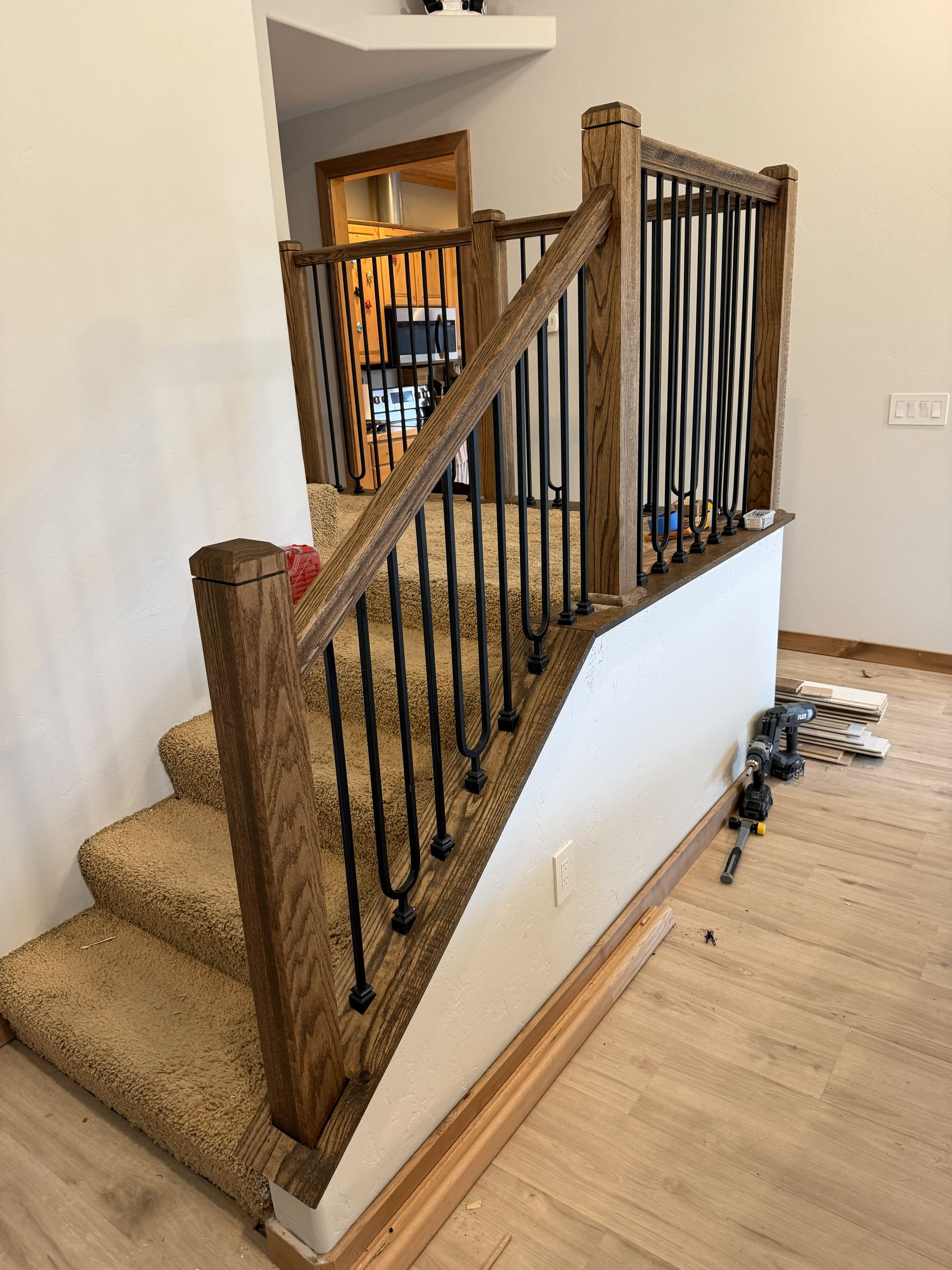 An empty living room with hardwood floors and a ceiling fan.