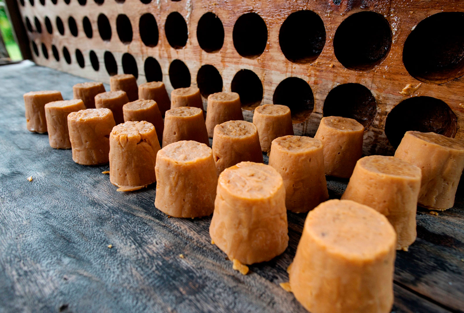 A bunch of small pieces of brown sugar molasses are sitting on a table.