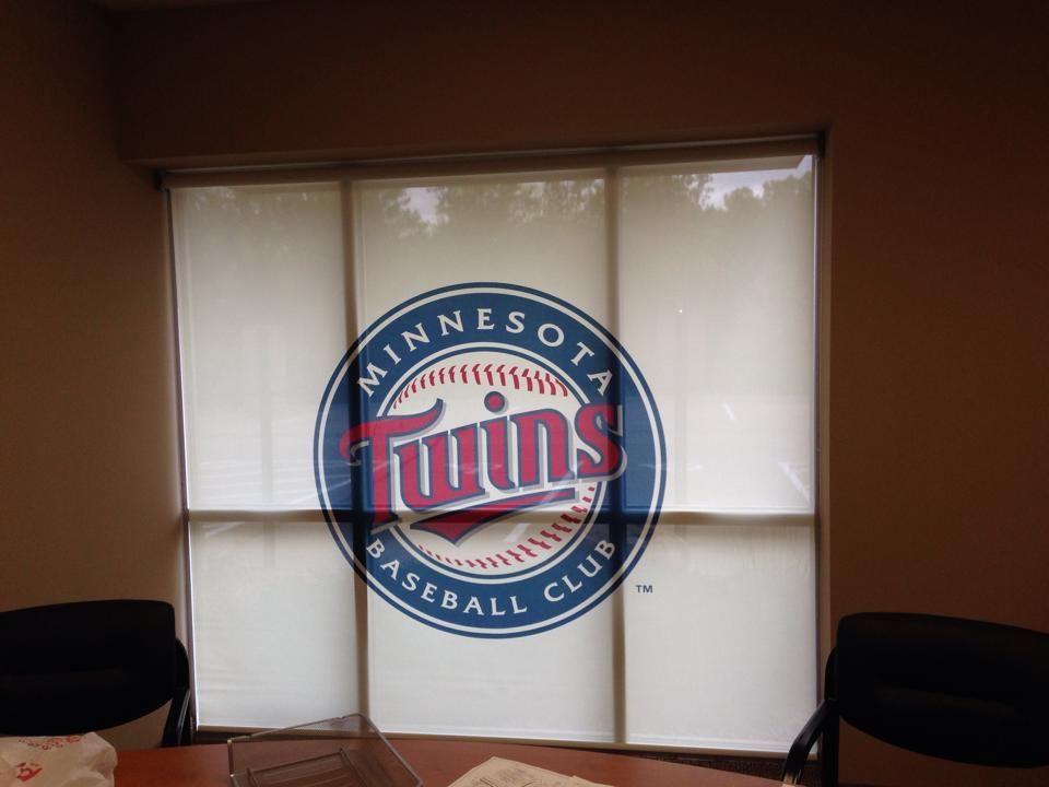 Minnesota Twins logo on a window blind in an office.