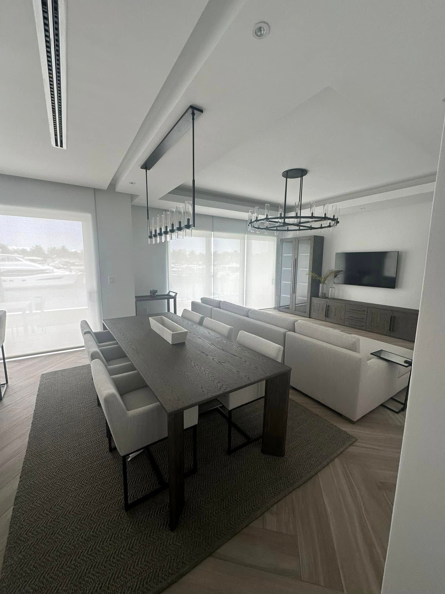 Small bathroom with floral window shade, toilet, and open door. Pinkish-tan walls, cream door, light wooden floor.