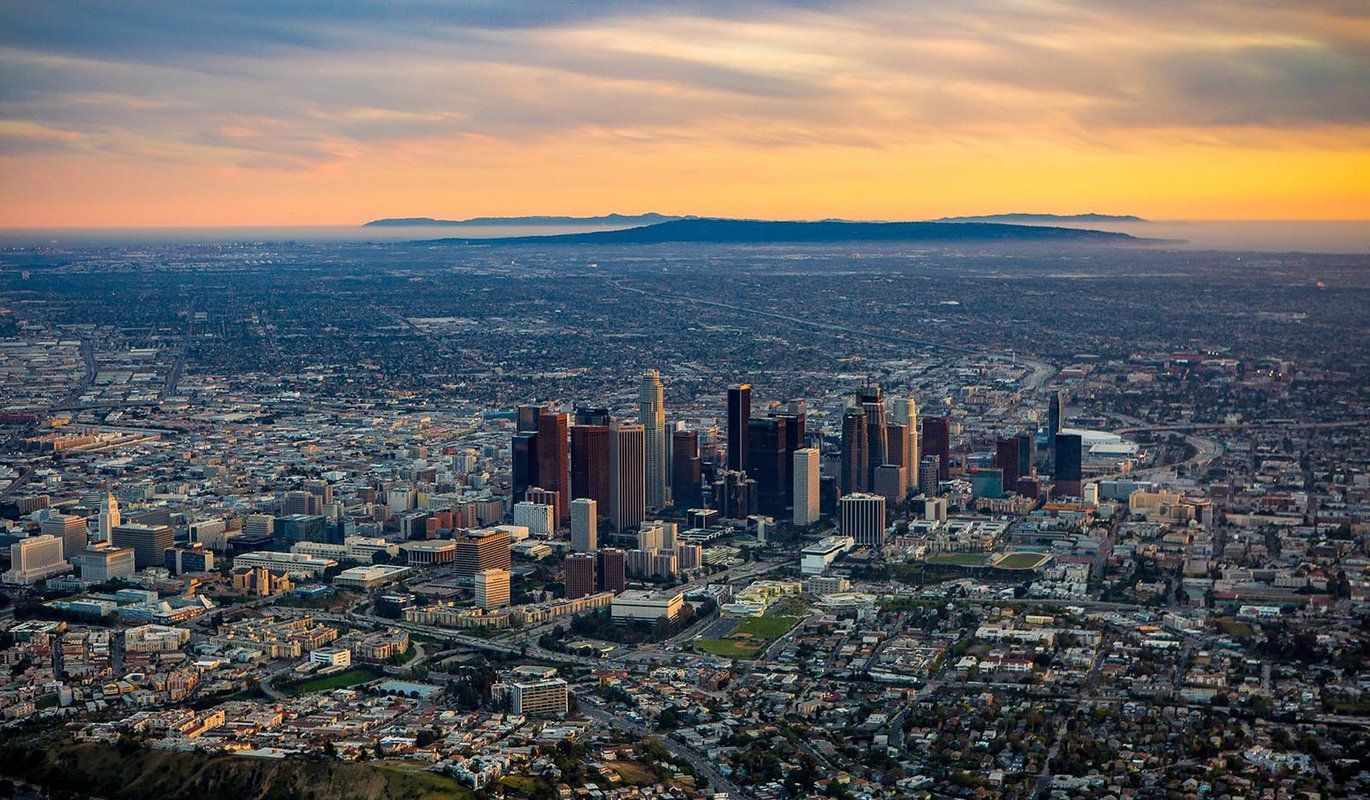 An aerial view of the city of los angeles at sunset.