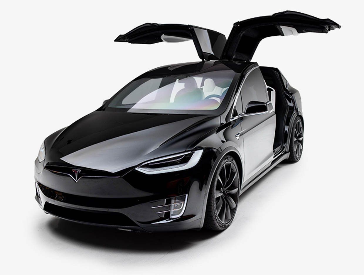 A black tesla model x with its doors open on a white background.