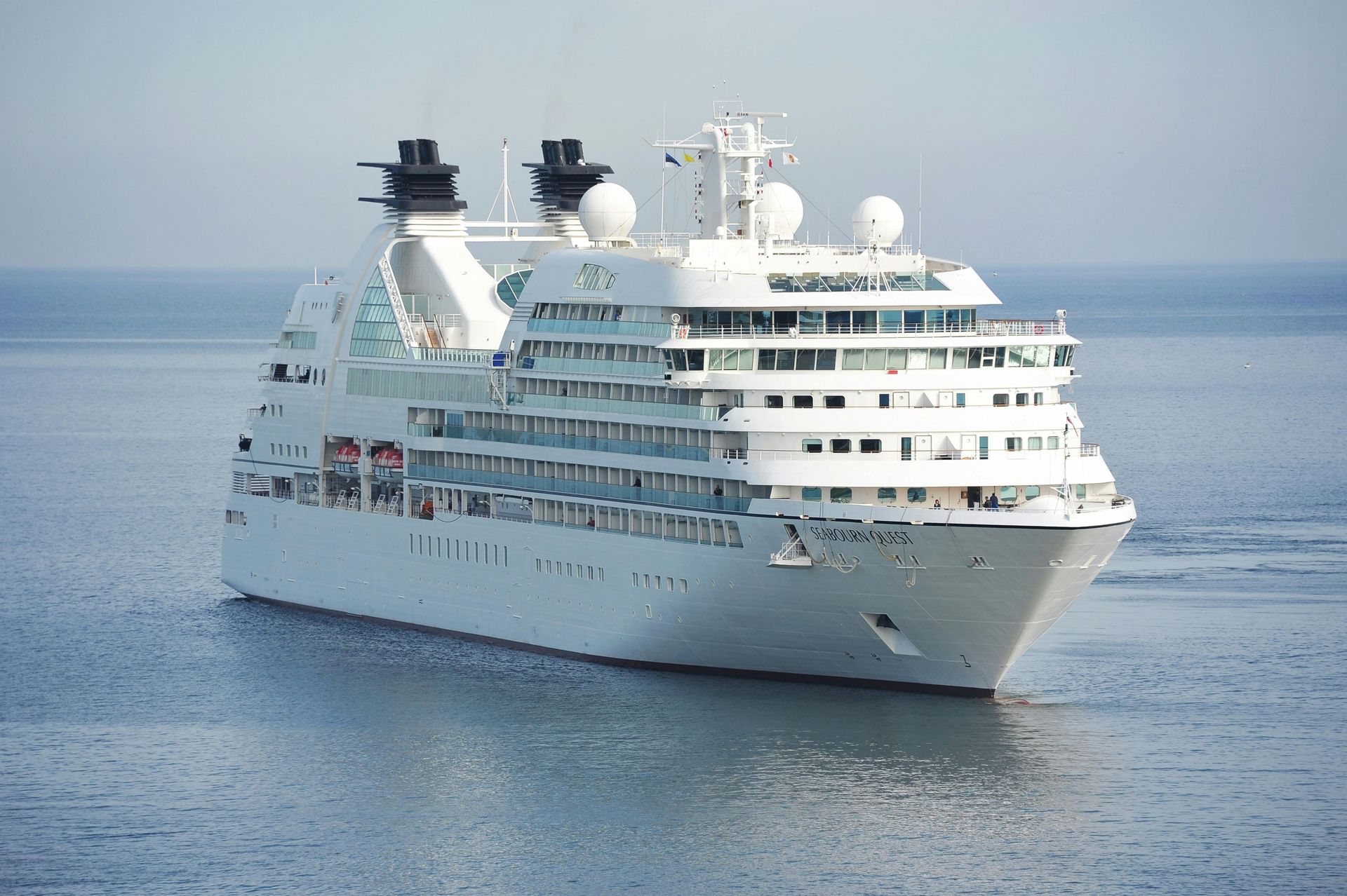 A large white cruise ship is floating in the ocean