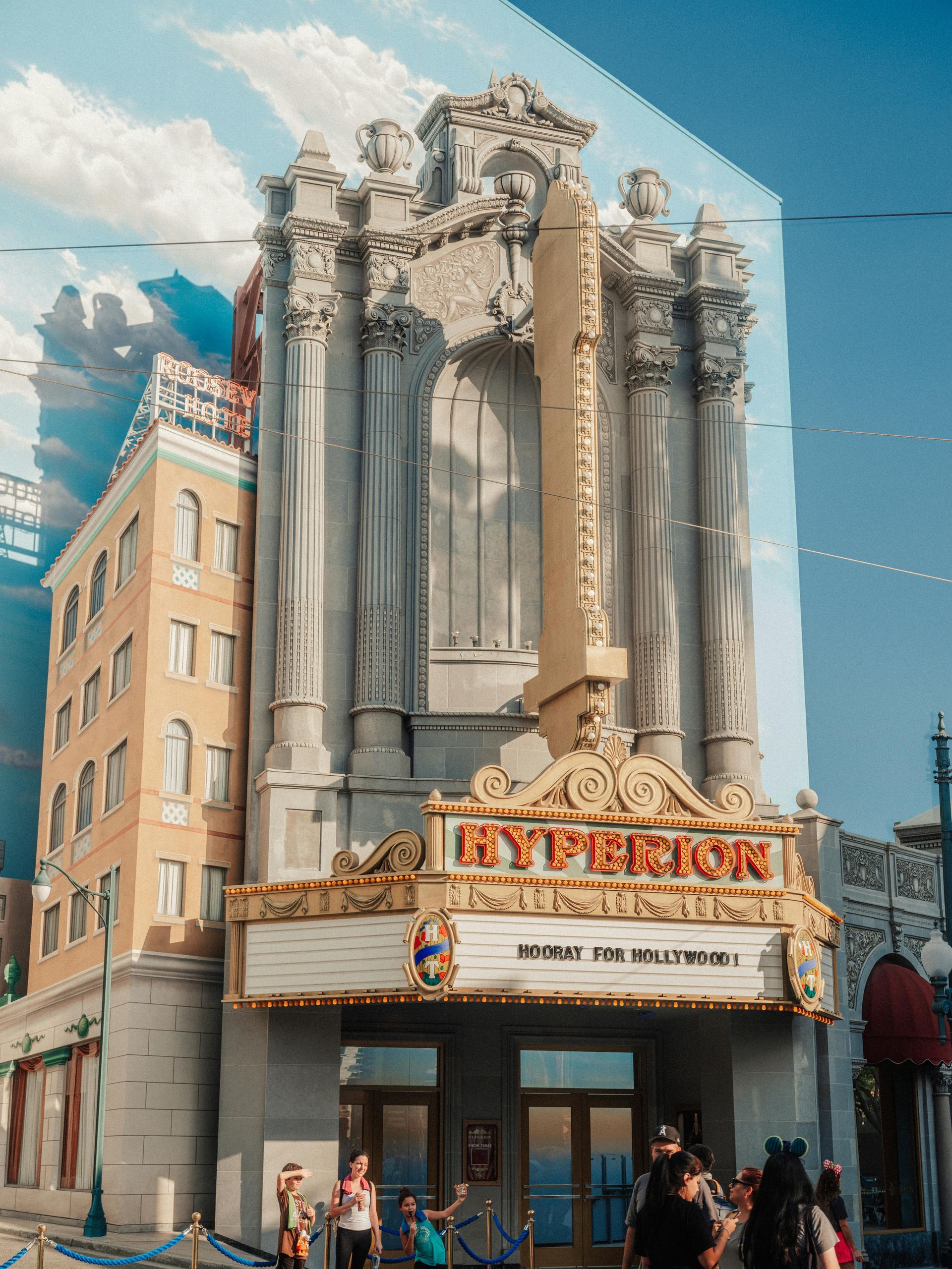 A group of people are standing in front of a large building.