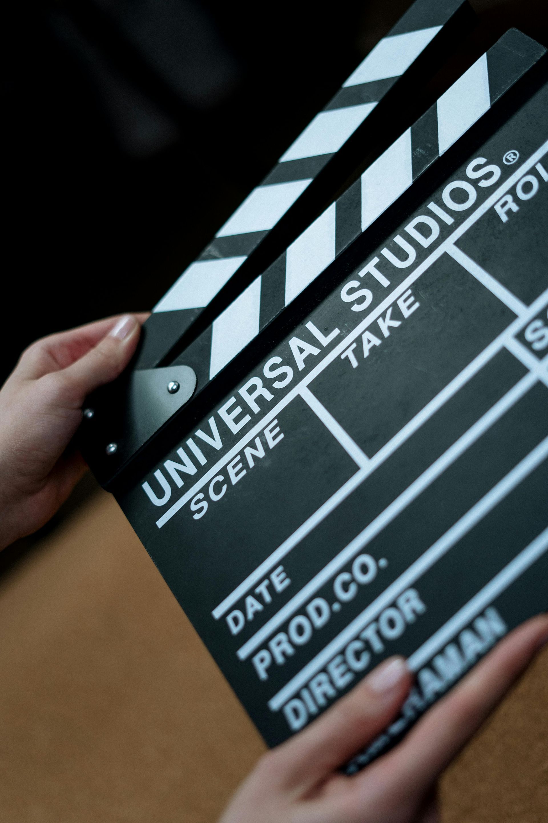 A person is holding a clapper board from universal studios