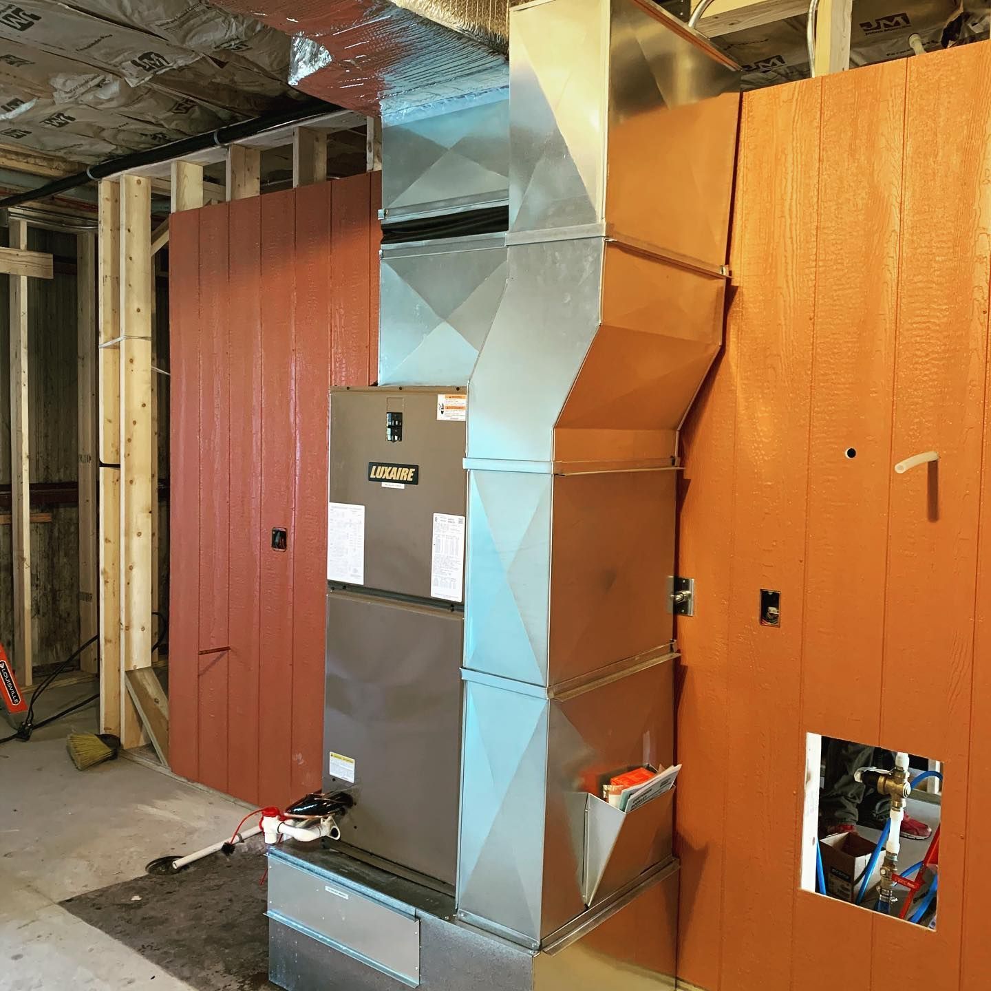 A room with a heater and a wall with a hole in it