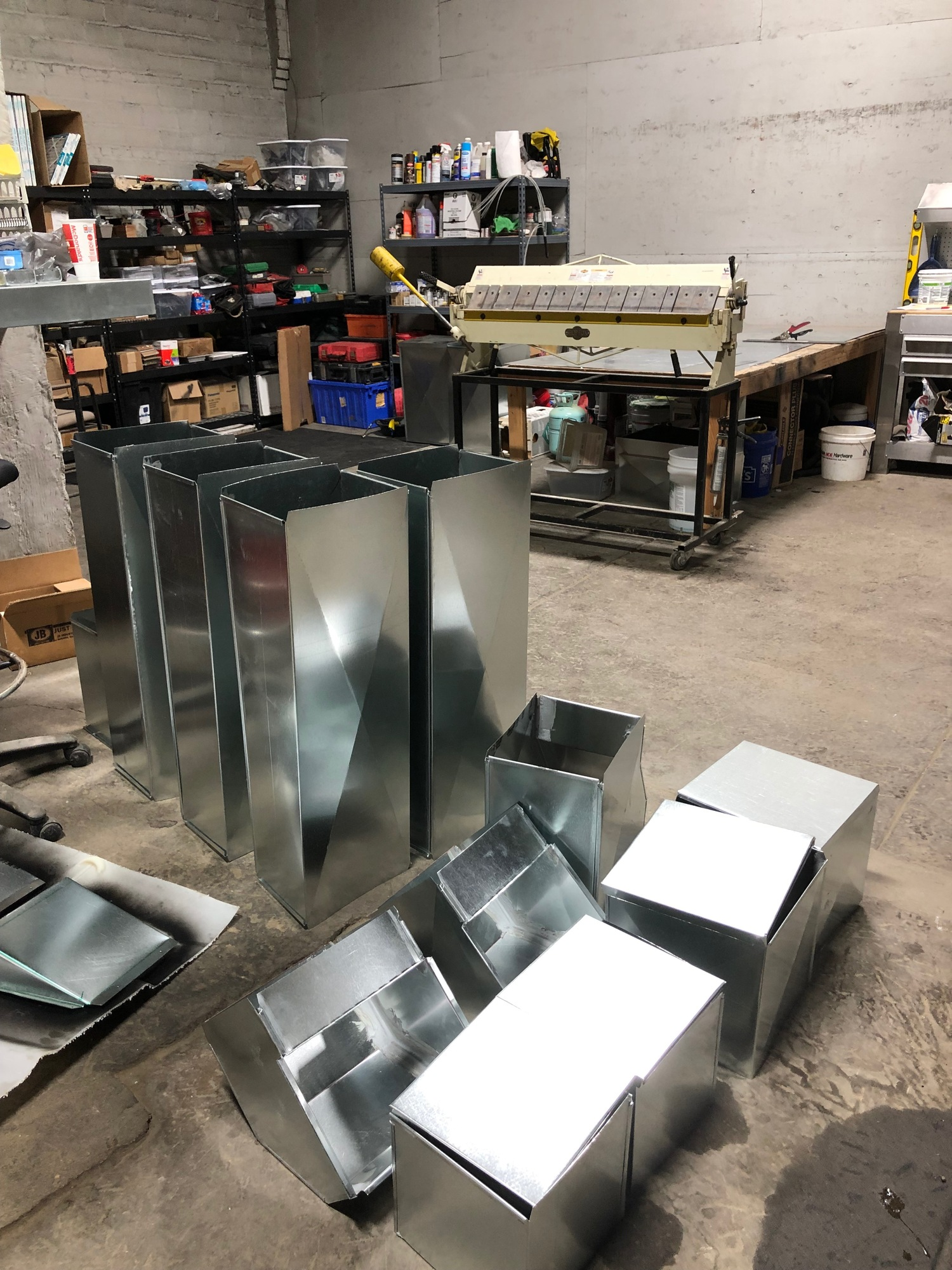 A bunch of metal boxes are sitting on the floor in a room.