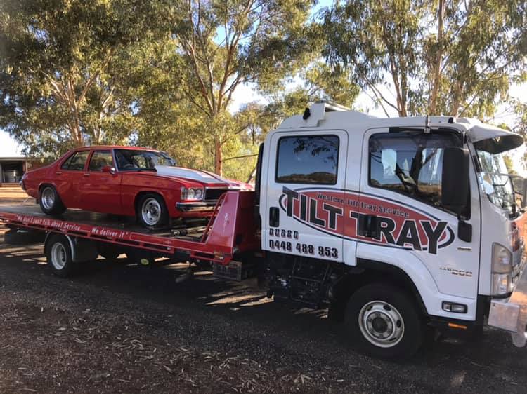 Truck Transporting red car — Towing in Dubbo, NSW
