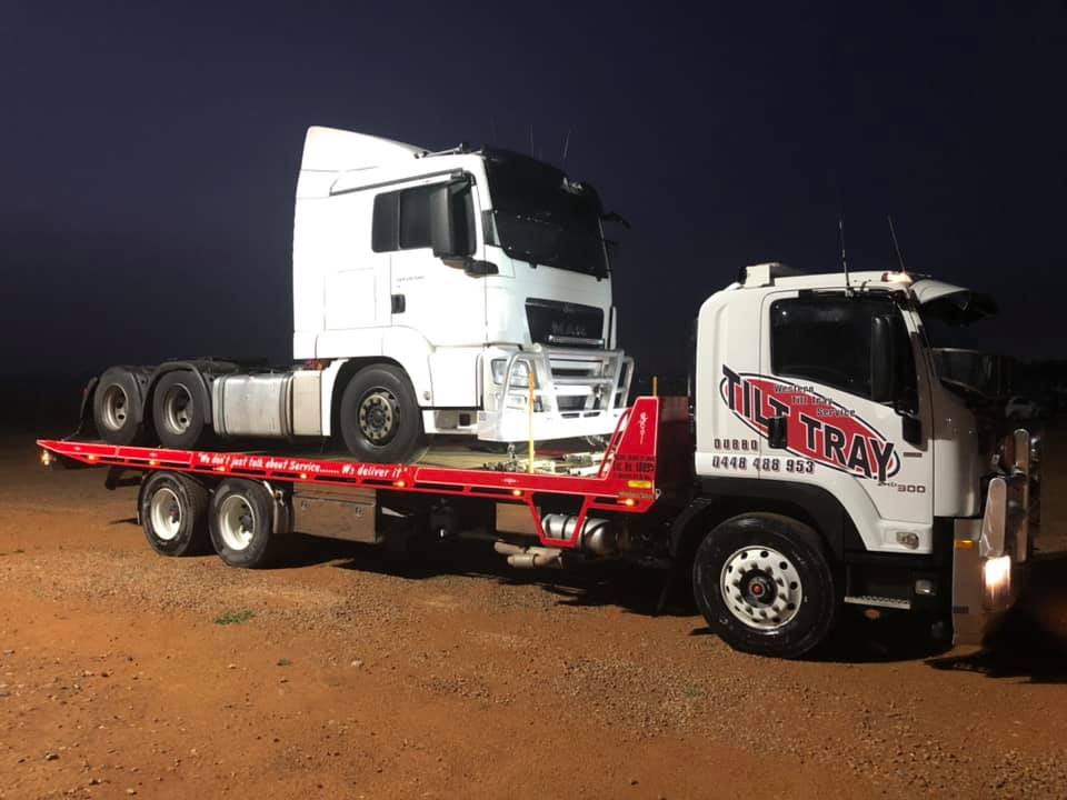 Truck Towing a white truck — Towing in Bourke in Dubbo, NSW