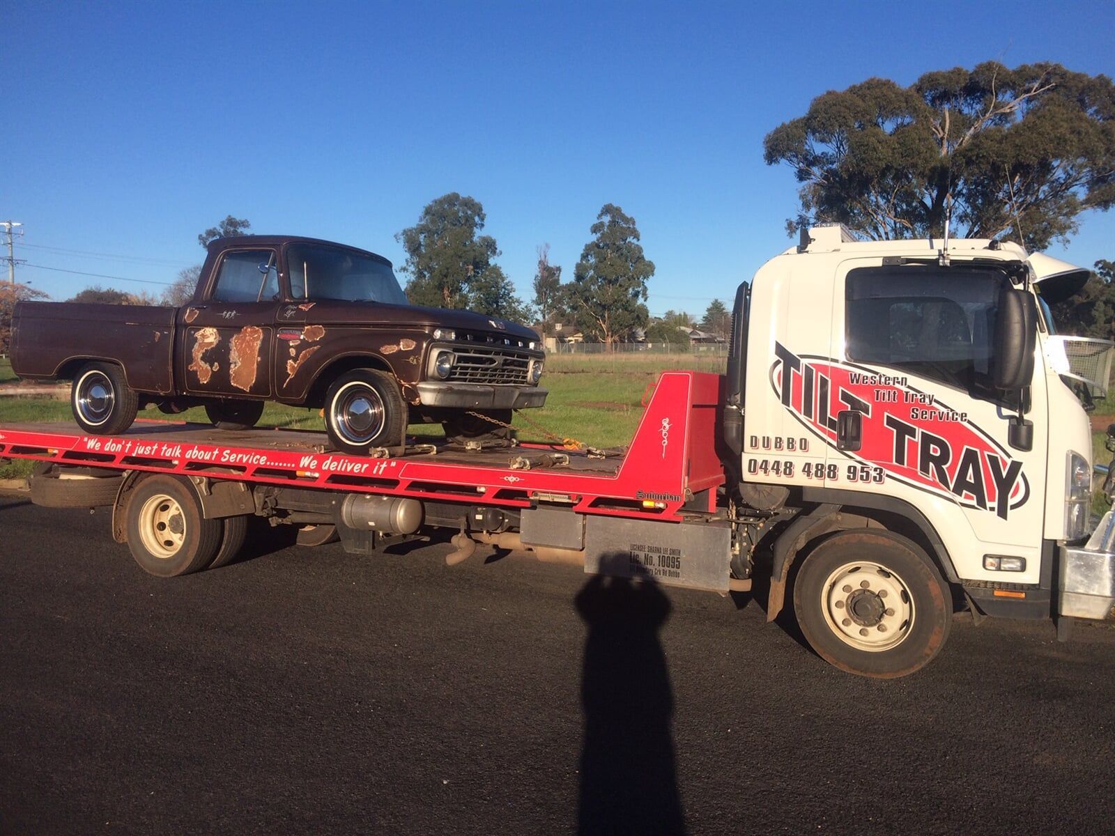 Truck Towing red car — Towing in Dubbo, NSW Truck Towing red car — Towing in Dubbo, NSW