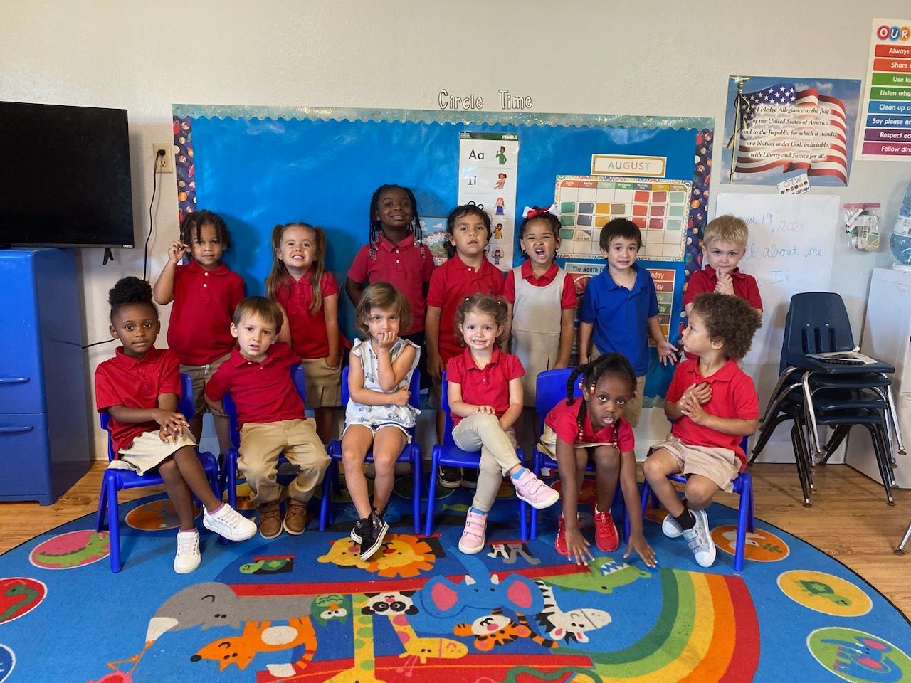A baby is sitting on the floor holding a book.