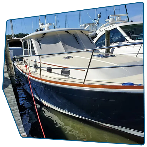 Blue and white motorboat docked at a marina with a wooden hull and tan trim. Blue and white motorboat docked at a marina with a wooden hull and tan trim.