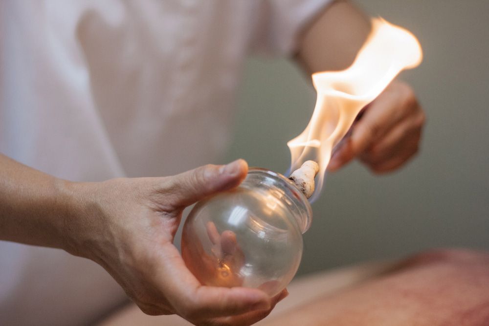 Woman Preparing Glass Cup With Fire For Cupping Therapy — Master Your Journey in Glenfield Park, NSW