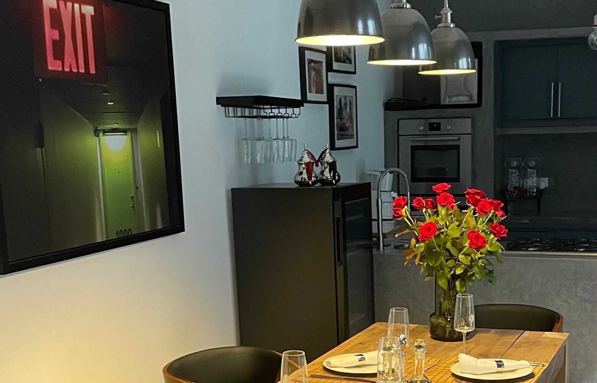 A picture of an exit sign hangs above a dining table