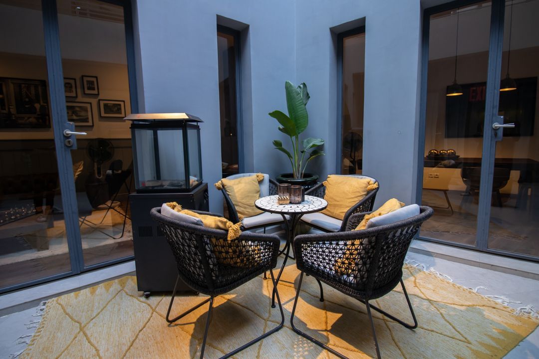 There is a table and chairs in the middle of the courtyard.