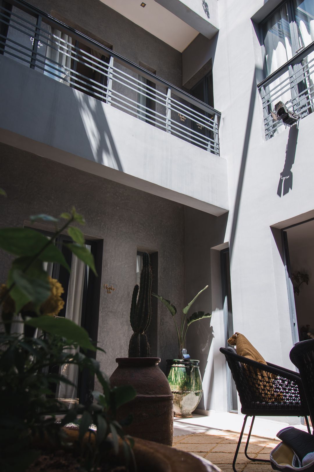 A building with a balcony and a chair in the middle of it