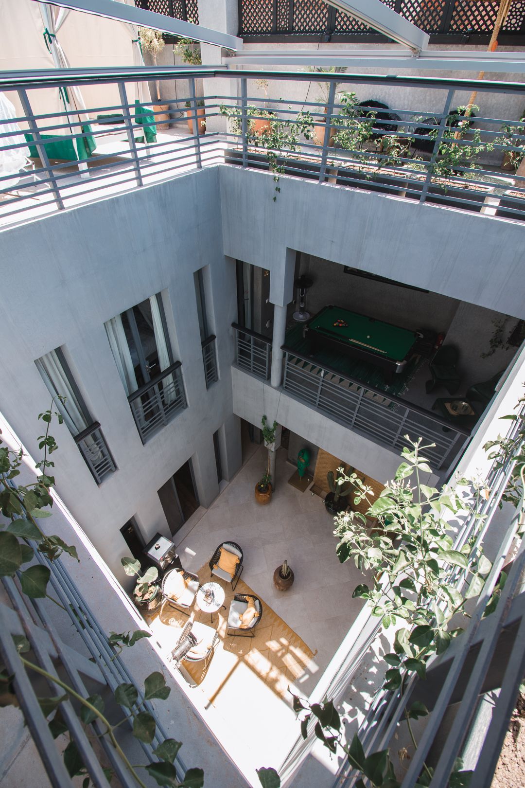 An aerial view of a building with a pool table in the middle