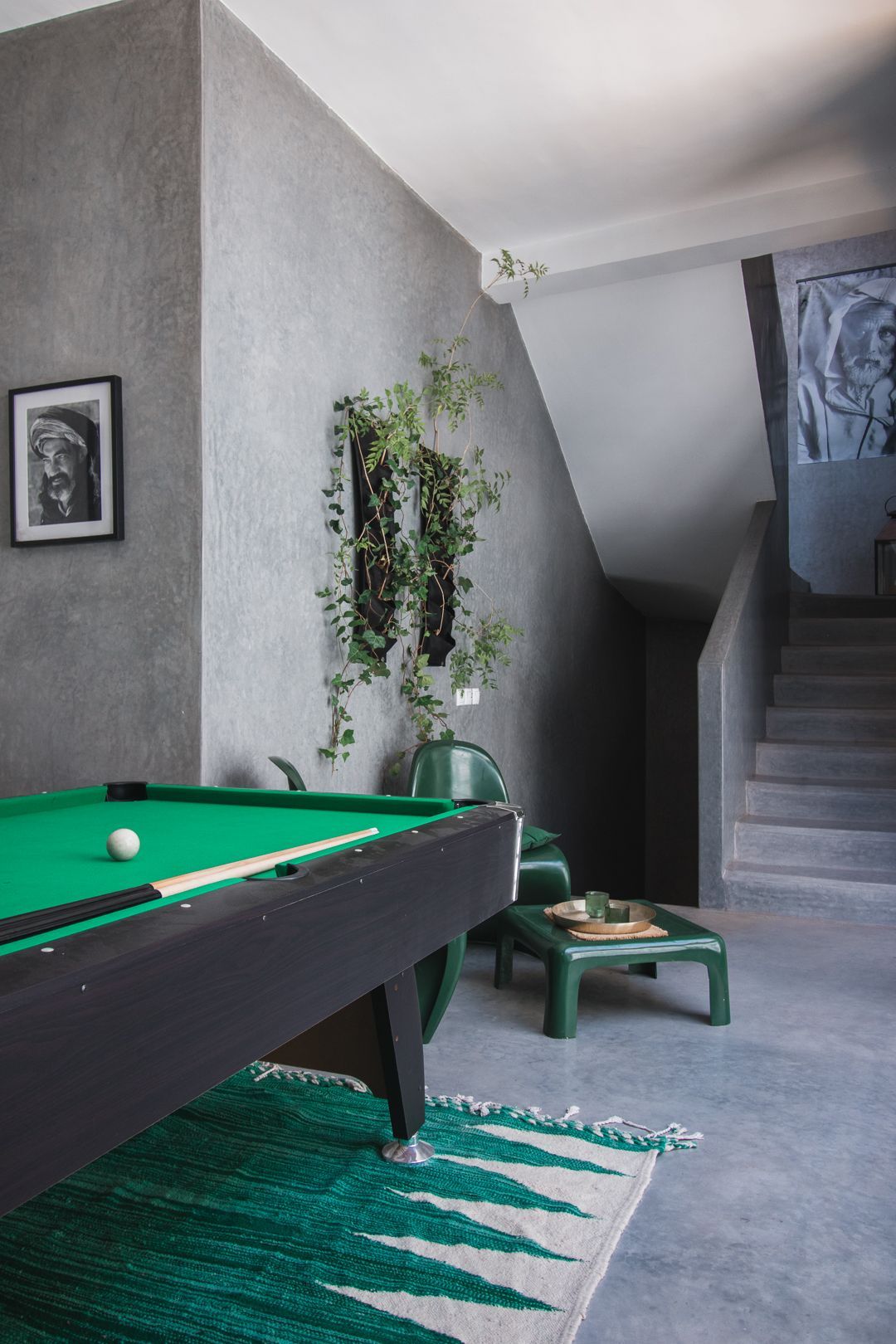 There is a pool table in the middle of the room.