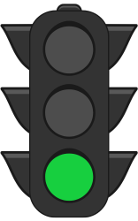 A black traffic light with a green light on it.