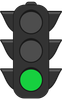 A black traffic light with a green light on it.