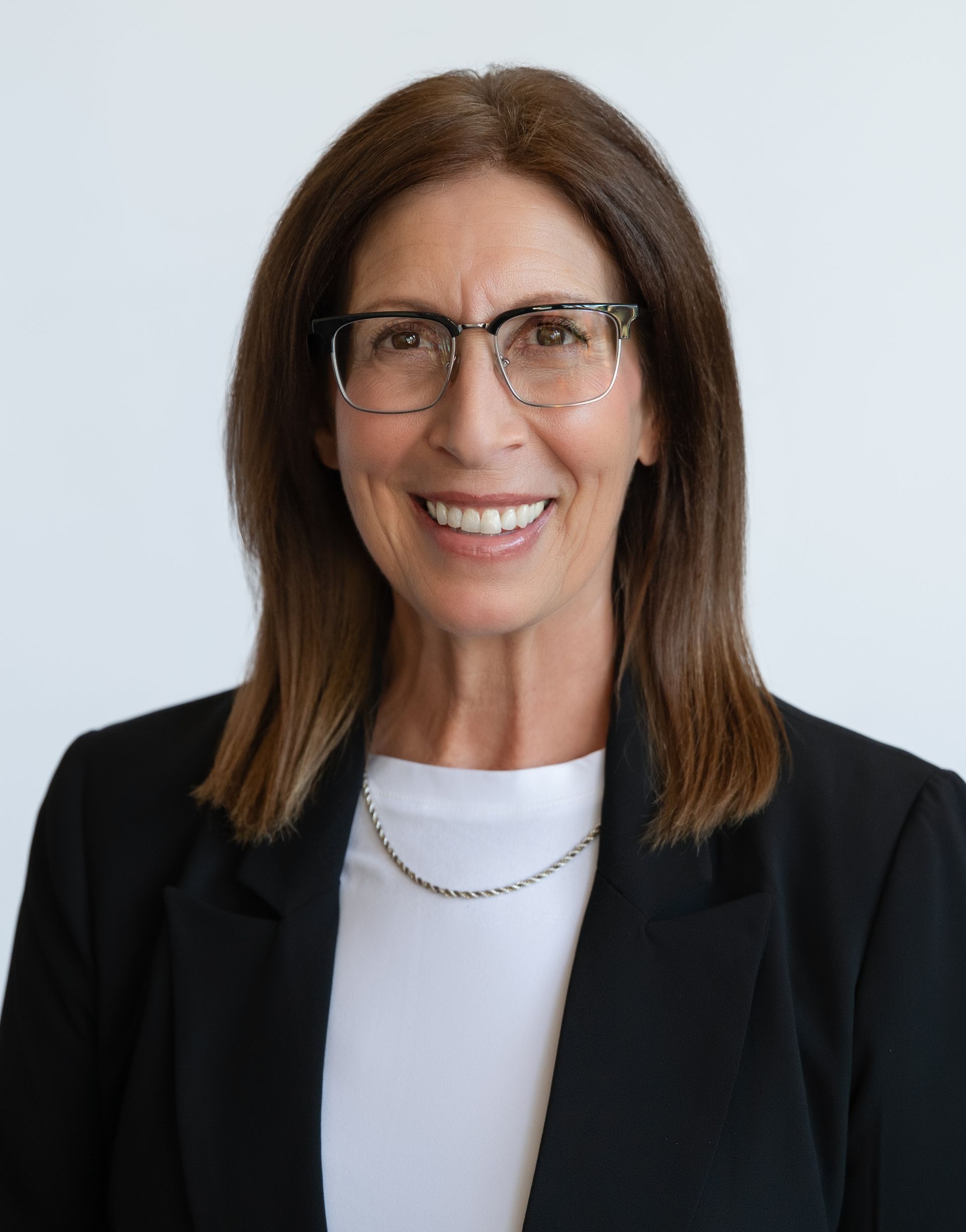 A man in a suit and tie is smiling for the camera.