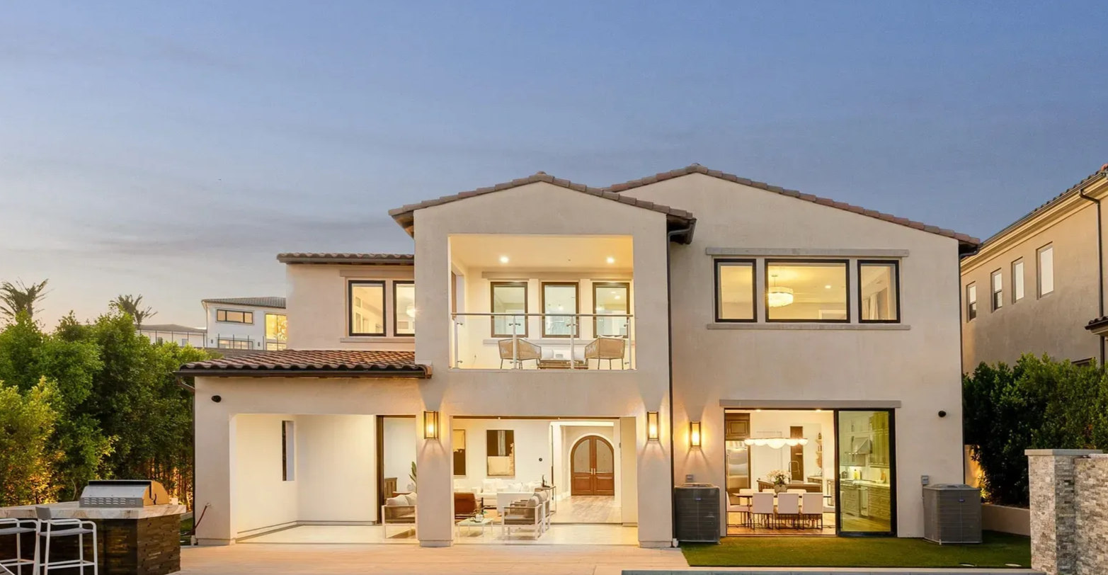 Cozy living room with a white couch, round coffee table, and sliding glass doors leading to a backyard.