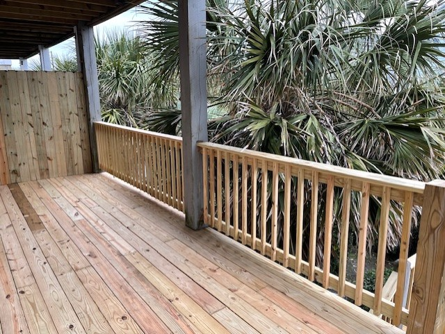Close-up of weathered wooden deck with a large hole, revealing dark space below. Close-up of weathered wooden deck with a large hole, revealing dark space below.